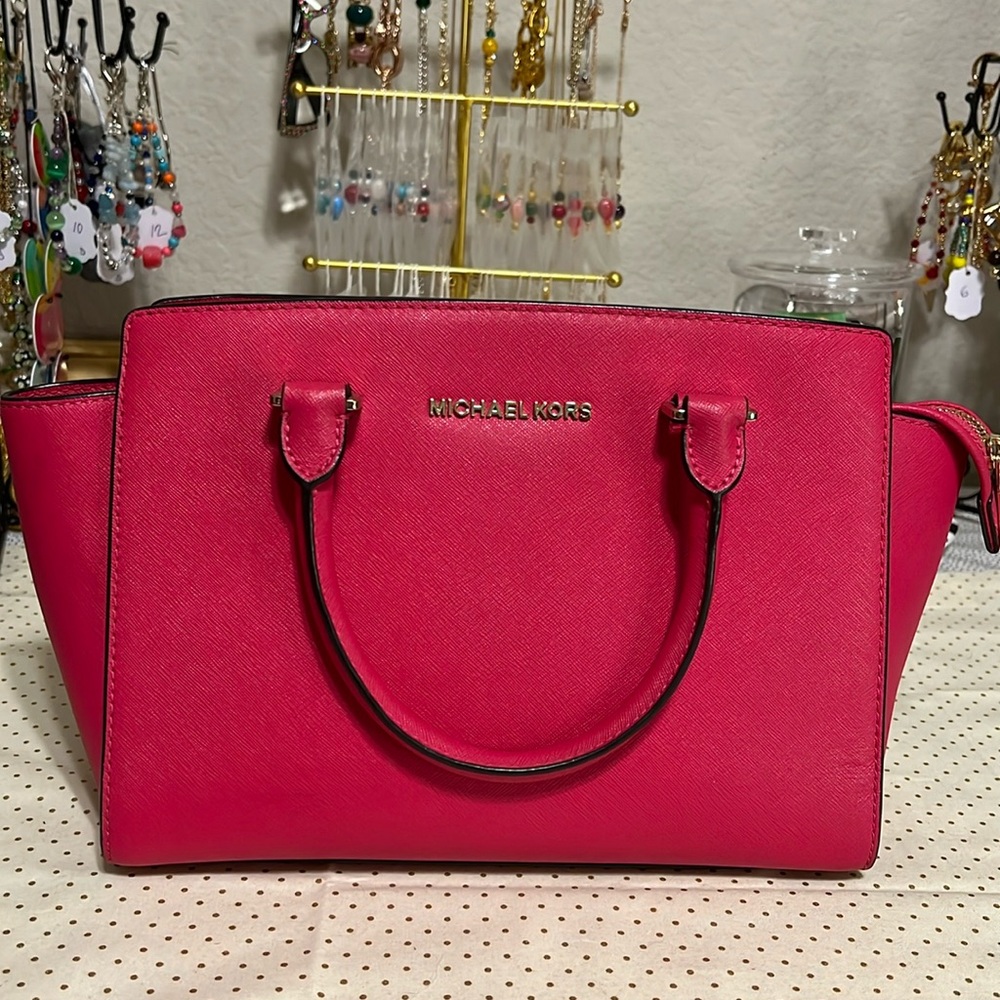 MICHAEL Kors “Selma” Saffiano leather bag with zip top closure.